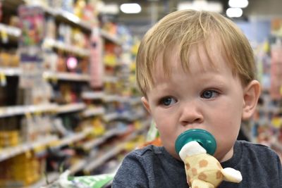 Close-up of cute toddler boy at supermarket