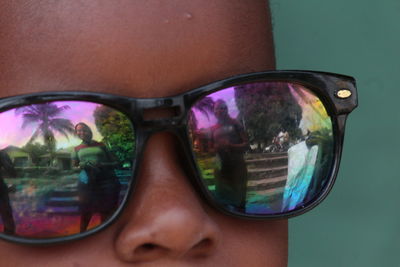 Reflection of woman photographing with sunglasses