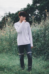 Full length of young man standing on field