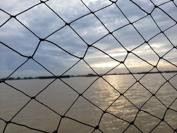 Full frame shot of chainlink fence against sky