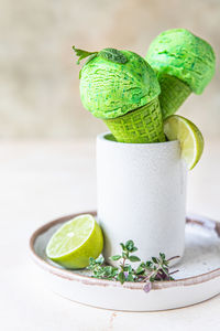 Close-up of green fruit on table