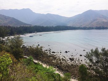 Scenic view of lake and mountains against sky