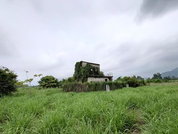 Built structure on field against sky