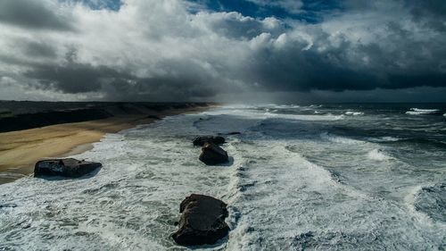 Scenic view of sea against cloudy sky