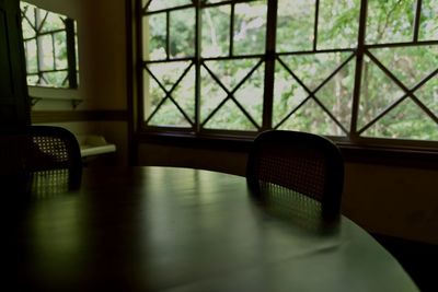 High angle view of table and chairs by window at home