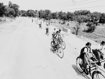 People riding bicycle on road in city