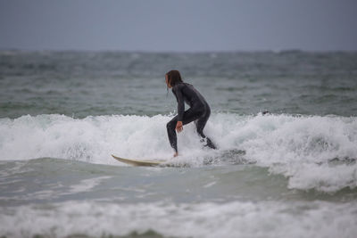 Full length of man surfing in sea