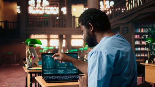 Side view of man using mobile phone in city at night