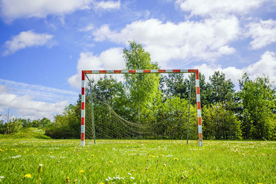 Solar panels on field against sky