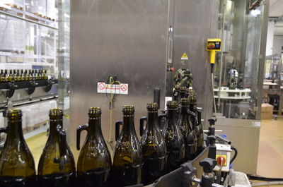 Glass of olive oil bottles on line in olive oil factory 