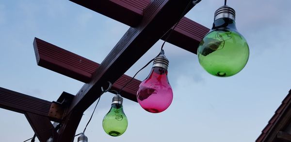 Low angle view of lanterns hanging against sky