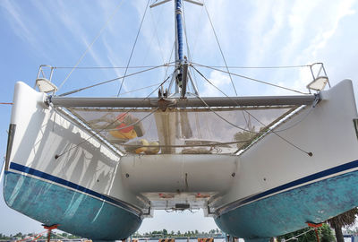 Low angle view of sailboat by sea against sky