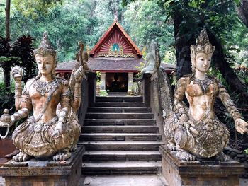 Statue outside temple against building