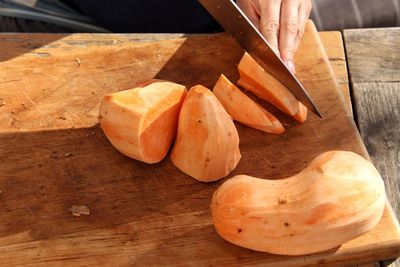 Close-up of person hand on cutting board