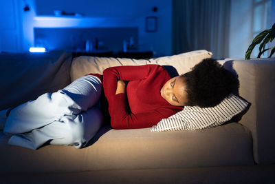 Stressful woman lying on couch suffer from relationship crisis, fight with boyfriend or heartbreak