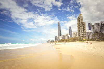 Panoramic view of beach and buildings against sky