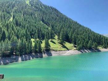 Scenic view of swimming pool by lake against sky