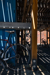 Bicycle parked by railing on bridge