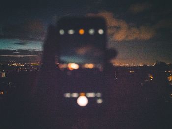 Portrait of illuminated city against sky at night