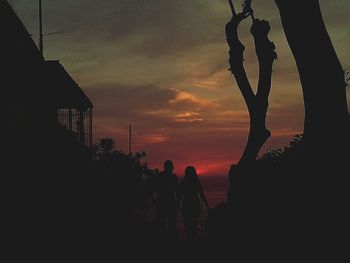 Silhouette of building against sky at sunset