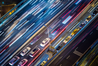 High angle view of light trails on road in city at night