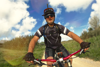 Man riding bicycle on field