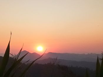 Scenic view of silhouette mountains against sky during sunset