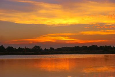 Scenic view of lake against romantic sky at sunset