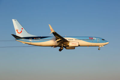 Airplane flying against clear blue sky