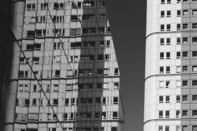 Low angle view of glass building with reflection