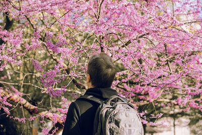 Rear view of woman standing against plants