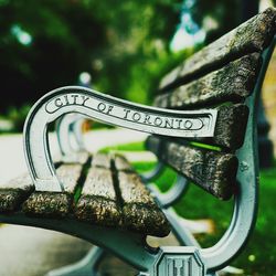 Close-up of metal bench in park