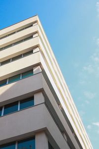 Low angle view of modern building against clear blue sky