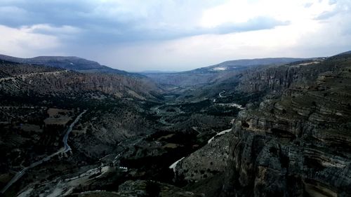 Scenic view of mountains against cloudy sky