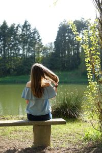 Rear view of teenage girl standing at park