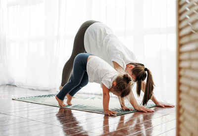 Mother and daughter exercising at home