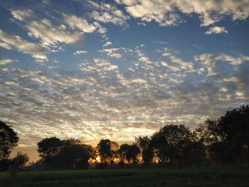 Scenic view of field against sky during sunset