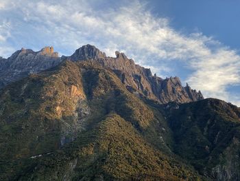 Low angle view of rocky mountains against sky