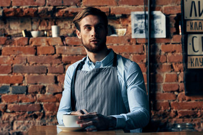 Portrait of young man drinking coffee