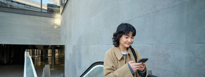 Portrait of young woman using mobile phone