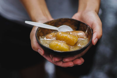 Close-up of hand holding ice cream