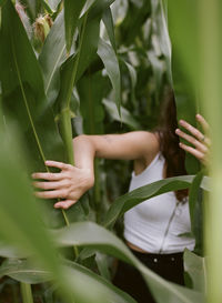 Close-up of woman standing by plant