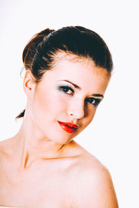 Close-up portrait of a beautiful young woman over white background