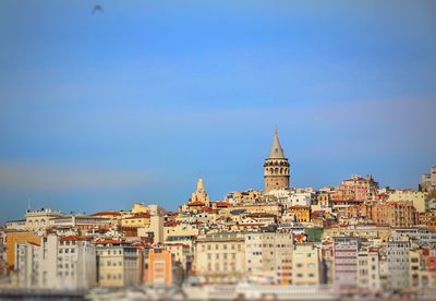 Buildings in city against clear sky