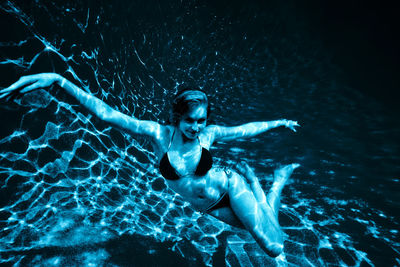 High angle view of woman swimming in pool