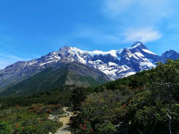 Scenic view of snowcapped mountains against clear blue sky