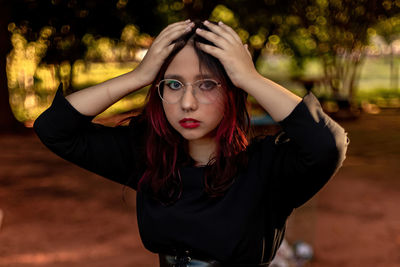 Portrait of teenager girl with hands on head