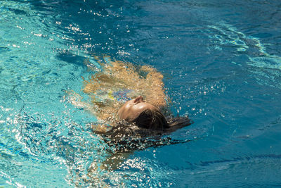 High angle view of woman swimming in pool