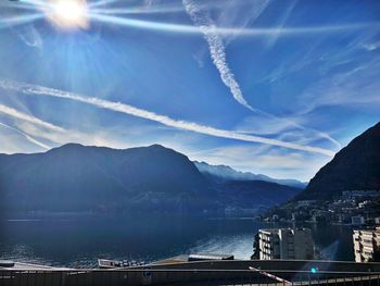 Scenic view of sea and mountains against sky