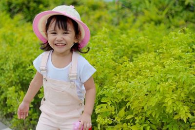 Portrait of a smiling girl standing outdoors